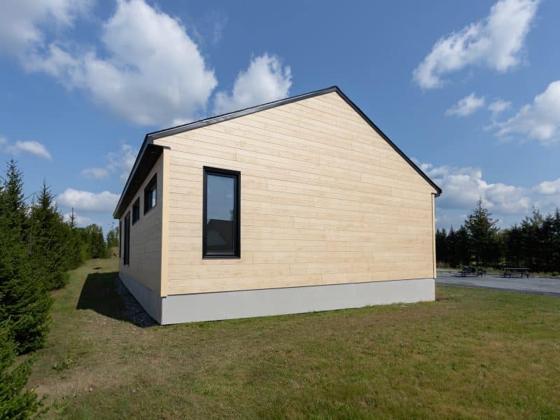 Une maison de plain-pied appelée Emile. Le premier étage est de style contemporain, vu de l'extérieur.